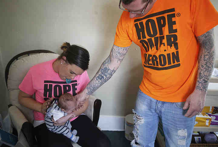 Jenn Kiser and Will Martin console their newborn, Dominic, while he fusses at their home in Akron. The couple was finally able to bring him home from the MICU as he battled withdrawal symptoms from methadone, a clinically administered opioid that eases cravings for heroin, Jenn was prescribed throughout her pregnancy to help her stay clean.   (Leah Klafczynski / Akron Beacon Journal)